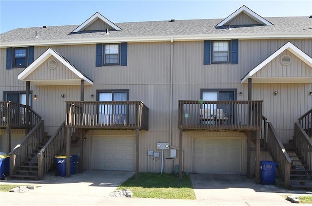 rear view of house featuring a garage