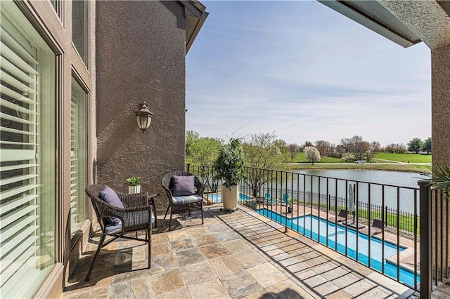 balcony featuring a water view and a patio area