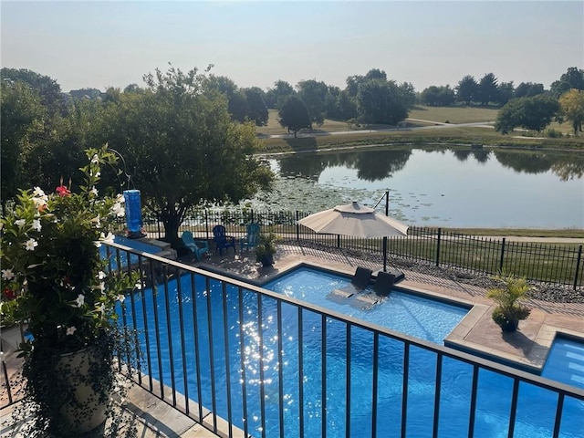 view of pool with a fenced in pool, a patio, a water view, and fence
