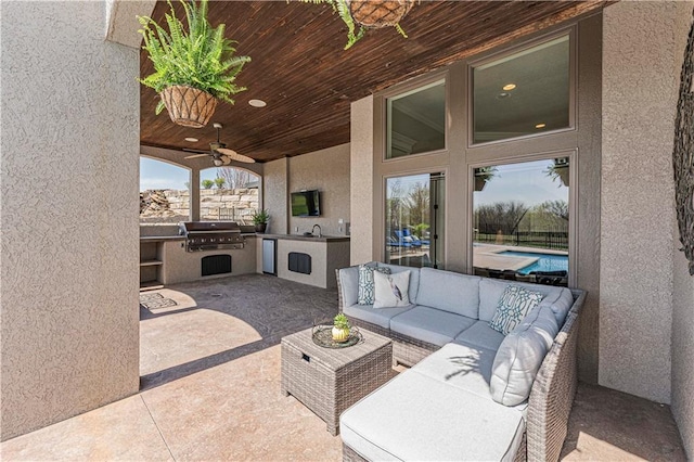 view of patio / terrace featuring ceiling fan, an outdoor hangout area, a grill, exterior kitchen, and an outdoor pool