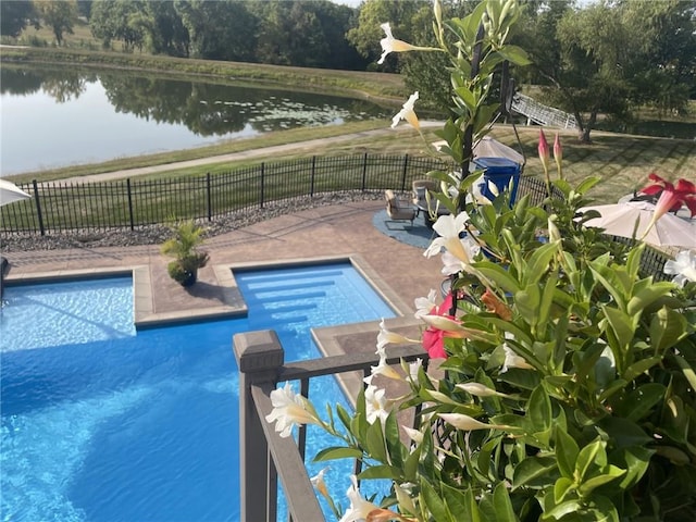 view of pool with fence, a water view, and a fenced in pool