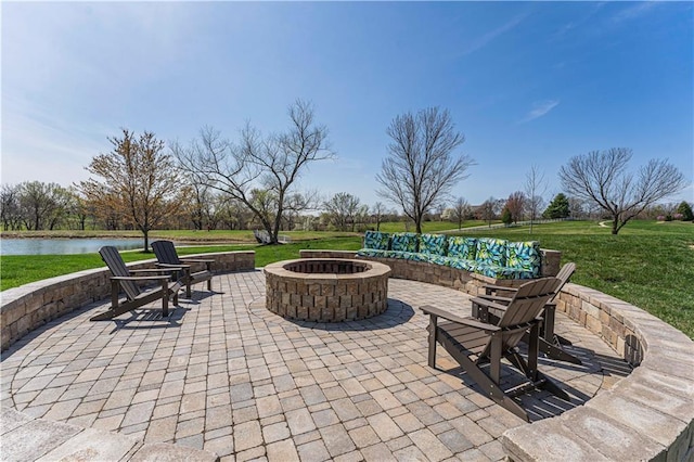 view of patio featuring an outdoor fire pit and a water view