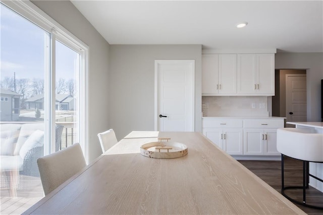 dining space with recessed lighting and dark wood finished floors