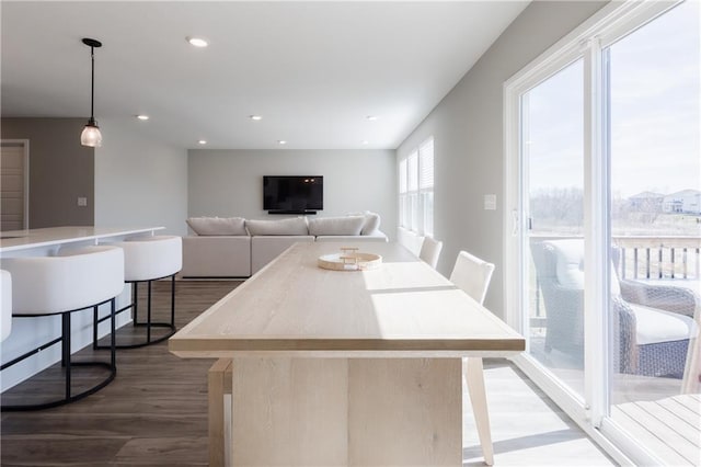 dining space with wood finished floors and recessed lighting