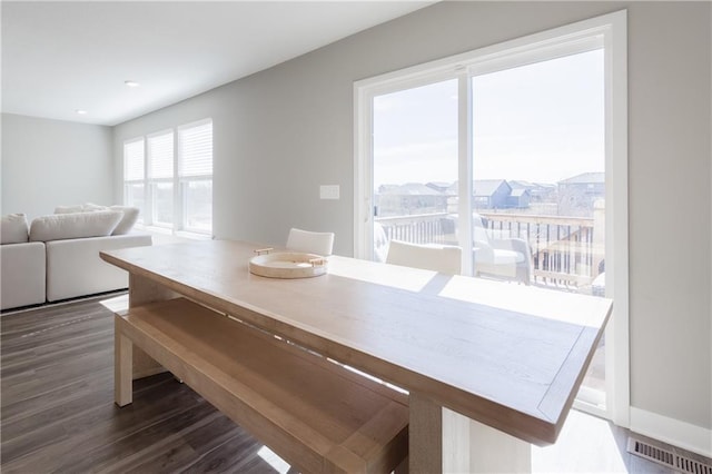 dining space with visible vents and dark wood finished floors