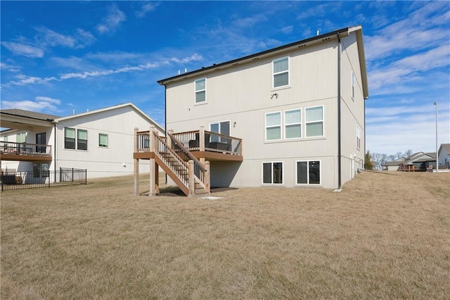 back of property featuring stairs, fence, a deck, and a yard