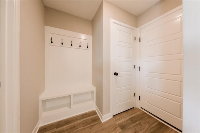 mudroom with wood finished floors and baseboards