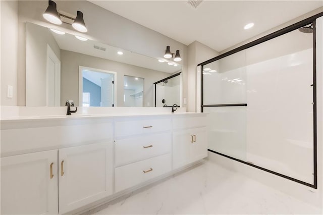 bathroom with double vanity, visible vents, marble finish floor, a shower stall, and recessed lighting