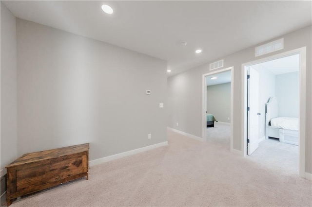 spare room featuring visible vents, light colored carpet, and recessed lighting