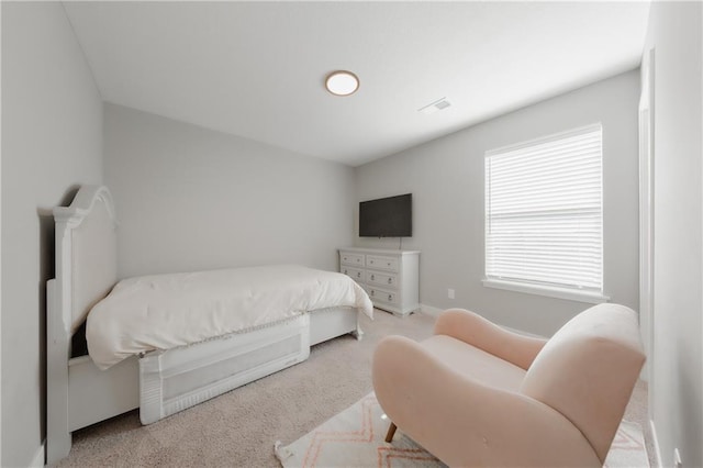 carpeted bedroom featuring visible vents