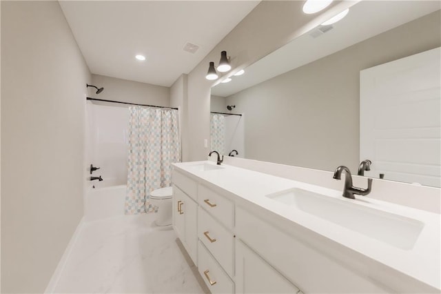 full bathroom featuring marble finish floor, double vanity, a sink, and toilet