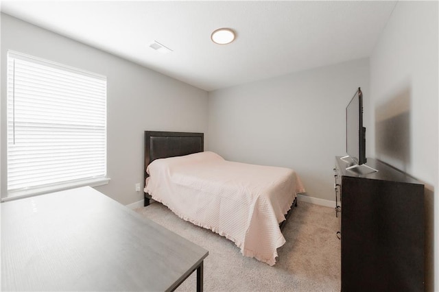 bedroom featuring light carpet, visible vents, and baseboards