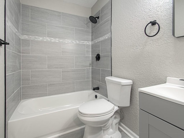 full bathroom with vanity, tiled shower / bath, and toilet