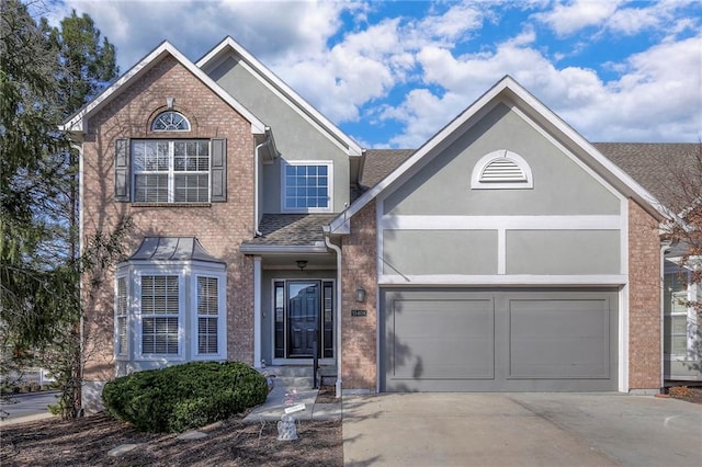 view of front of property with driveway, brick siding, a shingled roof, and stucco siding