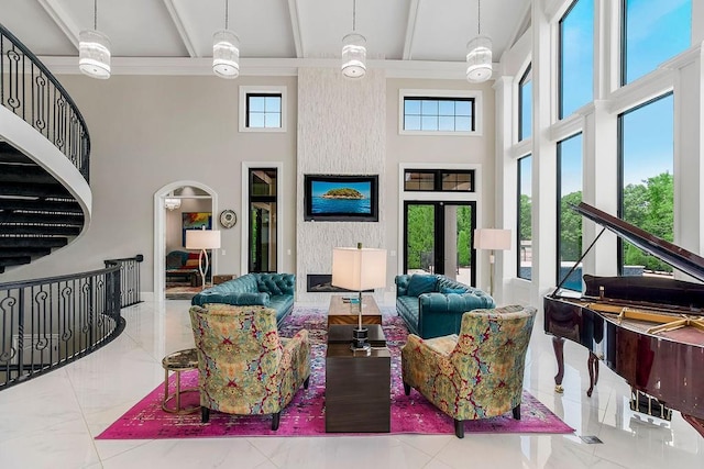 living area with marble finish floor, beam ceiling, a wealth of natural light, and french doors