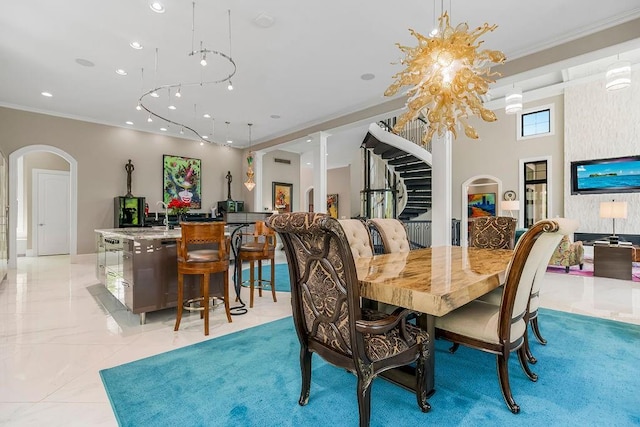 dining room featuring ornamental molding, arched walkways, marble finish floor, and stairs