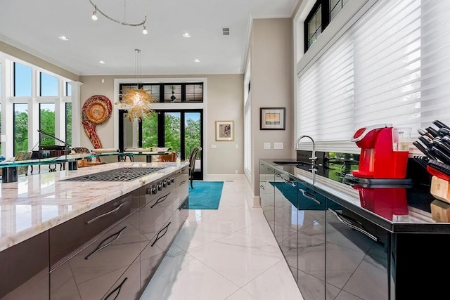 kitchen featuring modern cabinets, marble finish floor, stainless steel gas cooktop, a sink, and recessed lighting