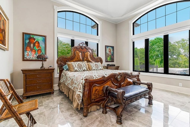 bedroom with marble finish floor, baseboards, and ornamental molding