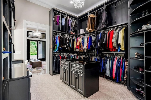 spacious closet featuring an inviting chandelier