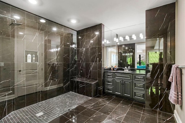 full bathroom featuring marble finish floor, walk in shower, and vanity