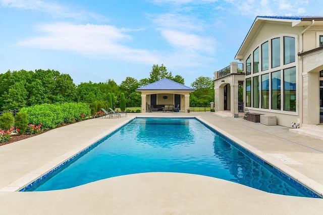 outdoor pool with a patio area