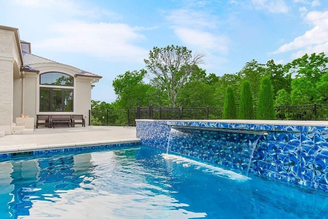 view of swimming pool featuring a fenced in pool, fence, and a patio