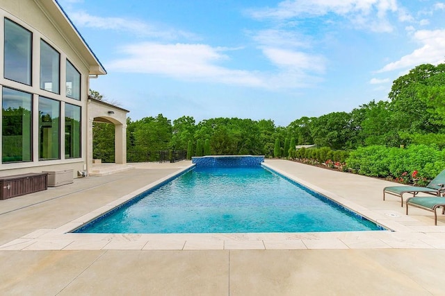 outdoor pool with a patio area