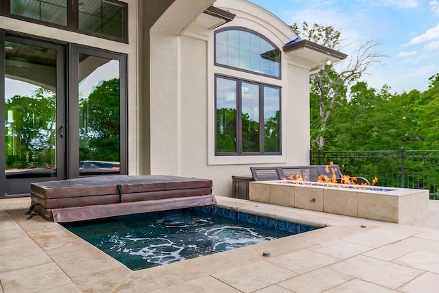 view of swimming pool with a patio area, an outdoor hot tub, and fence