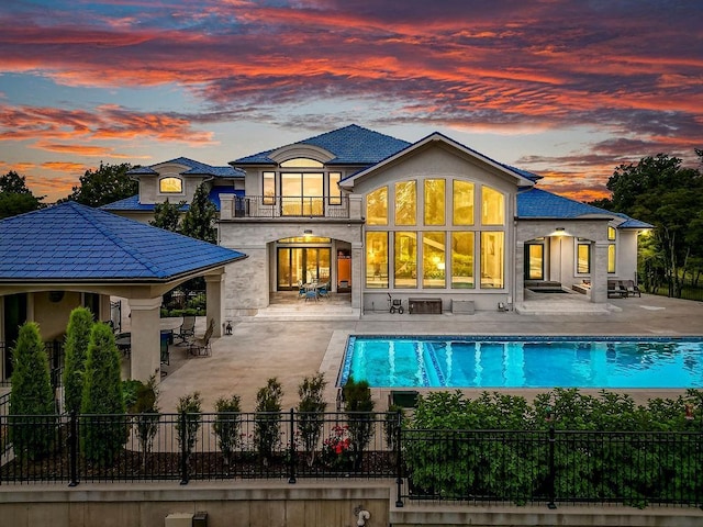 back of property with a patio, fence, and a balcony