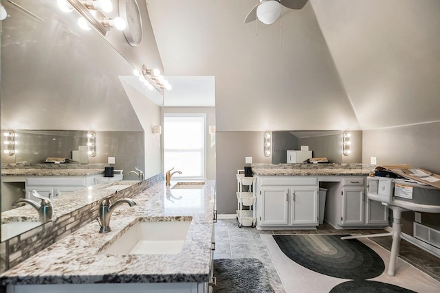 bathroom with lofted ceiling and vanity