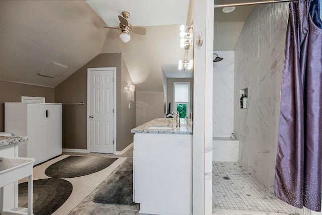 full bathroom featuring lofted ceiling, ceiling fan, vanity, and a marble finish shower