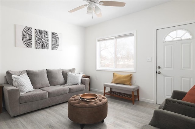 living room with light hardwood / wood-style flooring and ceiling fan