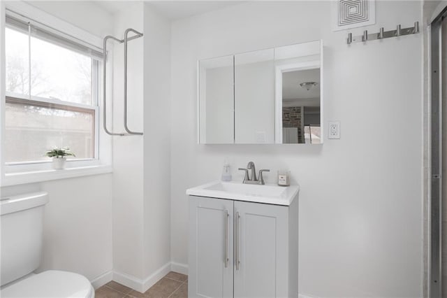 bathroom with vanity, toilet, and tile patterned flooring