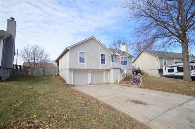 rear view of house with a garage and a yard