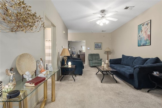 carpeted living room with ceiling fan