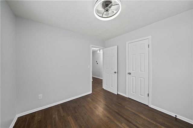 unfurnished bedroom with dark hardwood / wood-style flooring