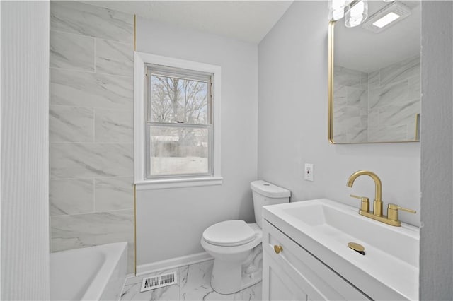 full bathroom featuring vanity, tiled shower / bath combo, and toilet