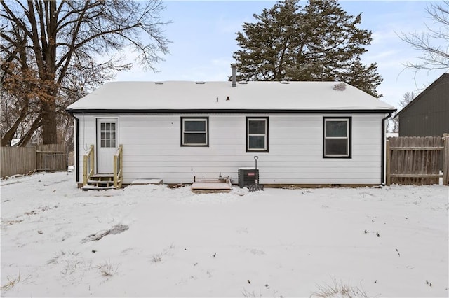 view of snow covered back of property