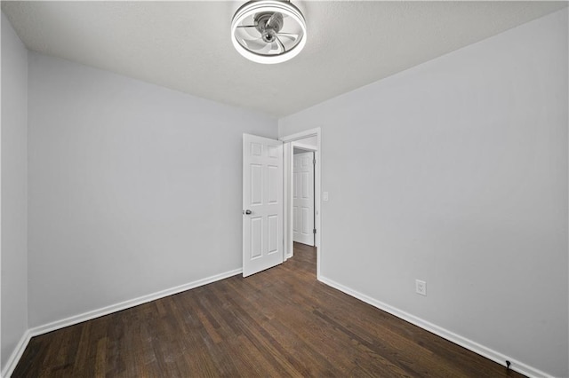 empty room with dark hardwood / wood-style floors