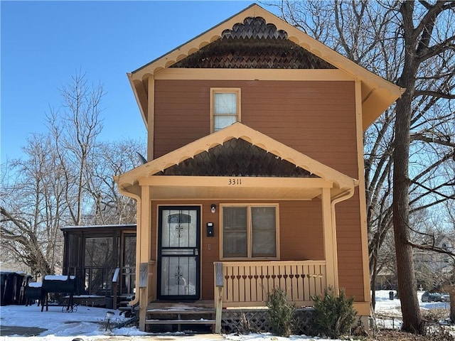 view of front of property featuring a sunroom and covered porch