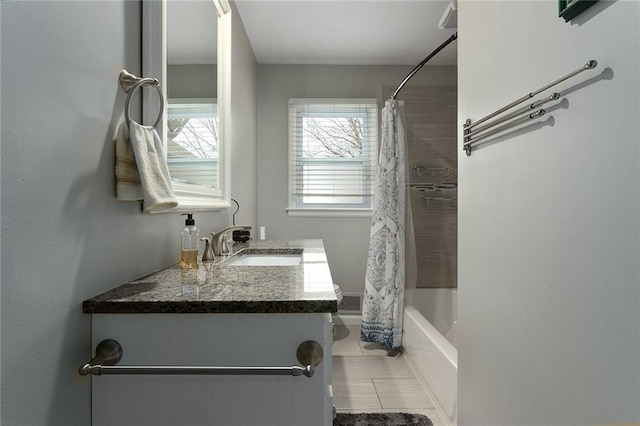 bathroom with tile patterned floors, vanity, and shower / bath combo with shower curtain