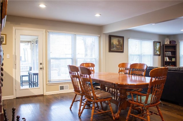 dining space with dark hardwood / wood-style floors