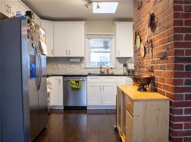 kitchen featuring stainless steel appliances and white cabinets