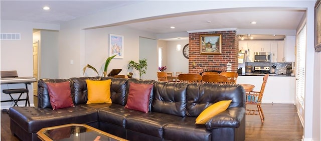 living room featuring a fireplace and wood-type flooring