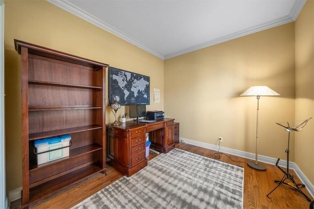 office area with crown molding, baseboards, and wood finished floors