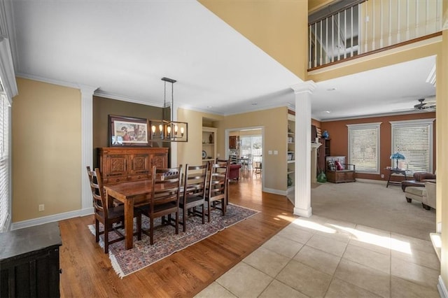 dining space featuring ornamental molding and decorative columns