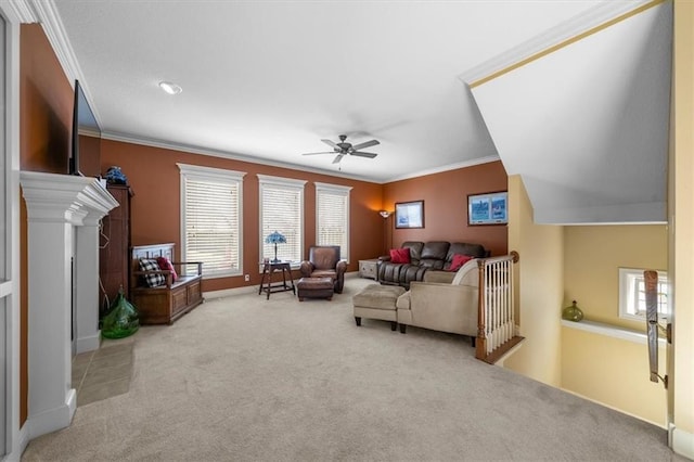 carpeted living area featuring crown molding, a ceiling fan, and baseboards