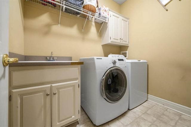 laundry area featuring cabinet space, baseboards, and separate washer and dryer