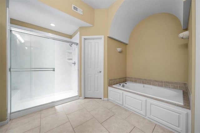 full bathroom featuring tile patterned flooring, a bath, visible vents, and a stall shower