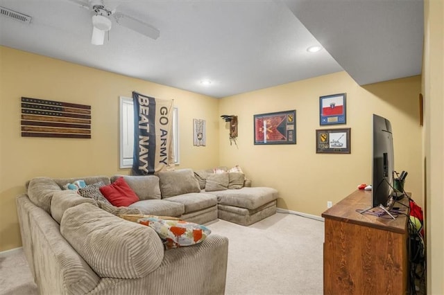 living area with baseboards, carpet, visible vents, and ceiling fan